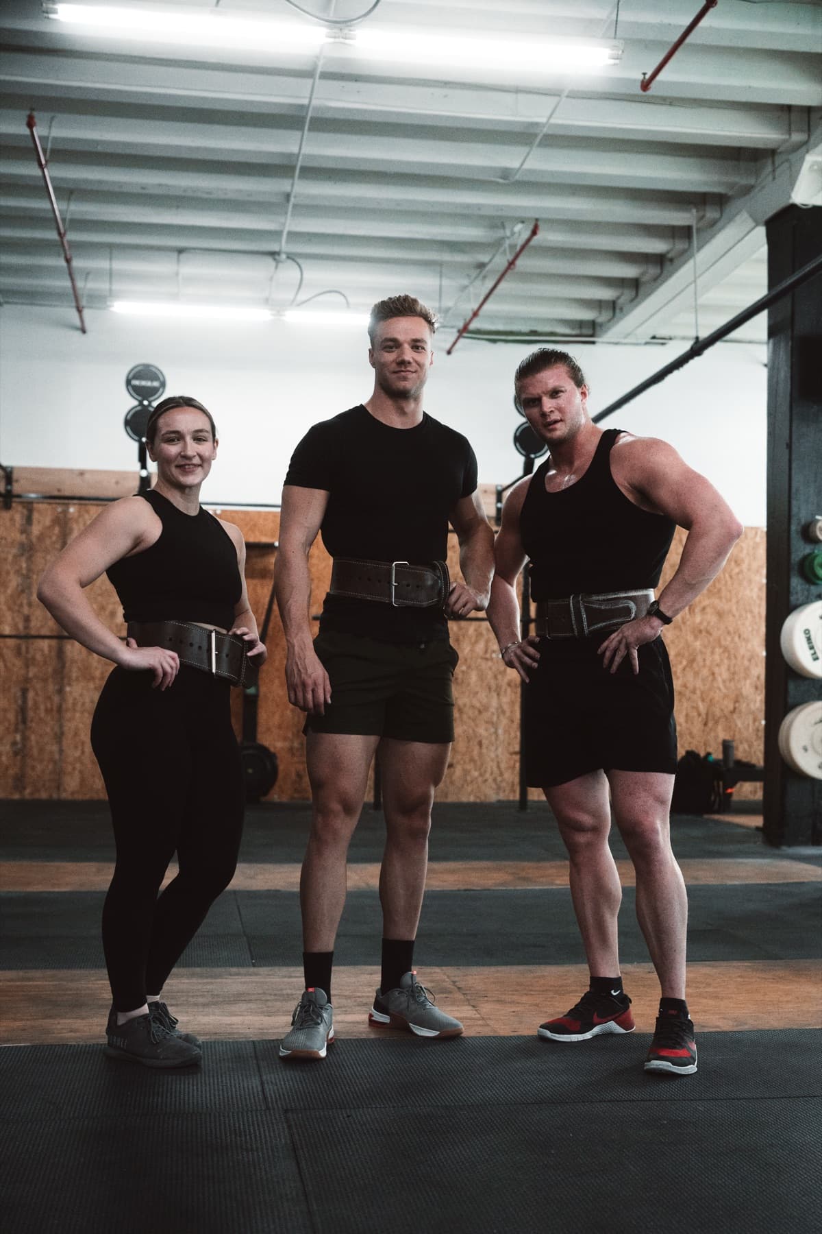 Lifter finishing a heavy deadlift in the gym.